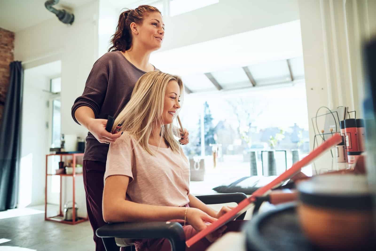 smiling woman looking at hair color samples with h utc min scaled
